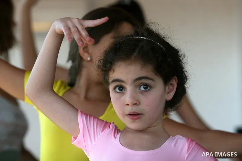 Palestinian girls take part in a ballet class at the Ramallah Ballet Center dance school in the West Bank city of Ramallah July 17, 2012. The center is the first in the occupied West Bank. Photo by Issam Rimawi