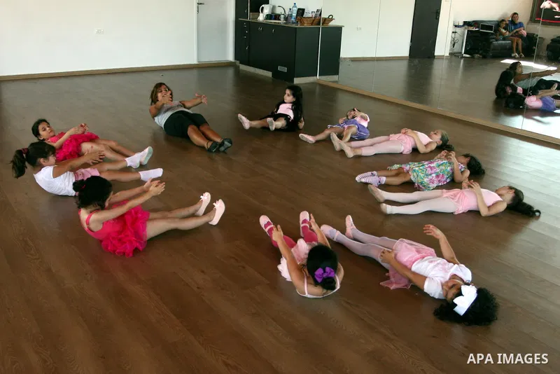 Palestinian ballet trainer, Shyrine Ziadeh , teaches young girls during summer classes at her Ramallah Ballet Center dance school, in the West bank town of Ramallah, 17 July 2012. The center teaches ballet techniques and...