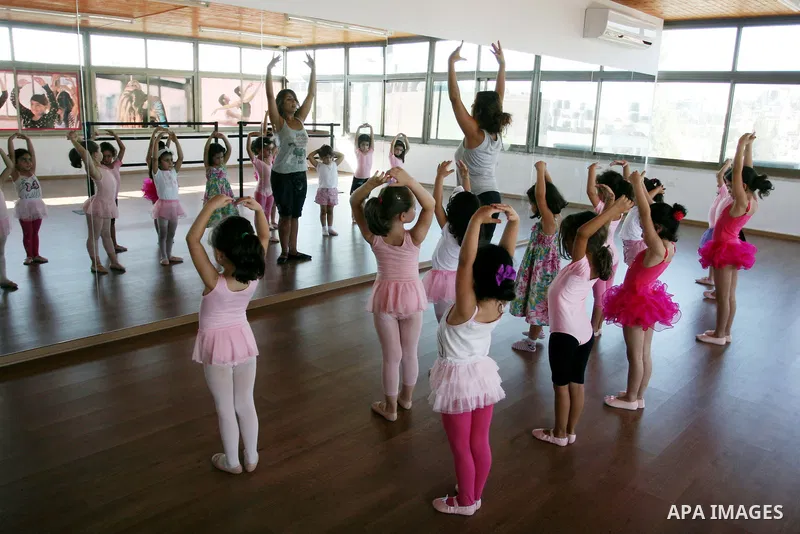 Palestinian ballet trainer, Shyrine Ziadeh , teaches young girls during summer classes at her Ramallah Ballet Center dance school, in the West bank town of Ramallah, 17 July 2012. The center teaches ballet techniques and...