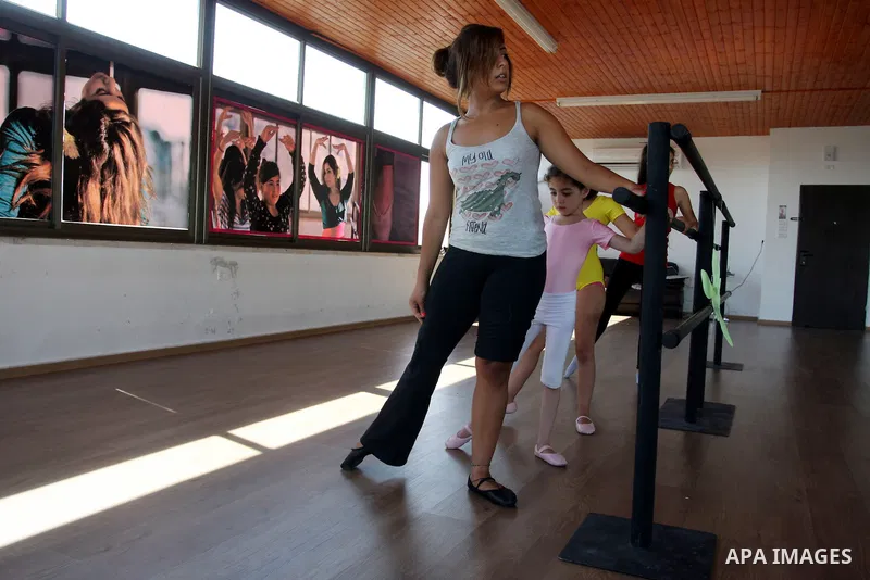 Palestinian girls lean on bars during a ballet class at the Ramallah Ballet Center dance school in the West Bank city of Ramallah July 17, 2012. The center is the first in the occupied West Bank. Photo by Issam Rimawi