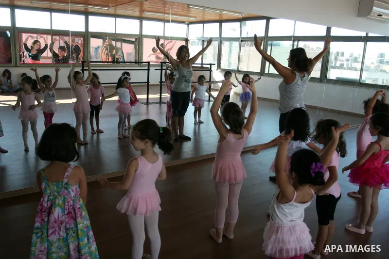 Palestinian ballet trainer, Shyrine Ziadeh , teaches young girls during summer classes at her Ramallah Ballet Center dance school, in the West bank town of Ramallah, 17 July 2012. The center teaches ballet techniques and...