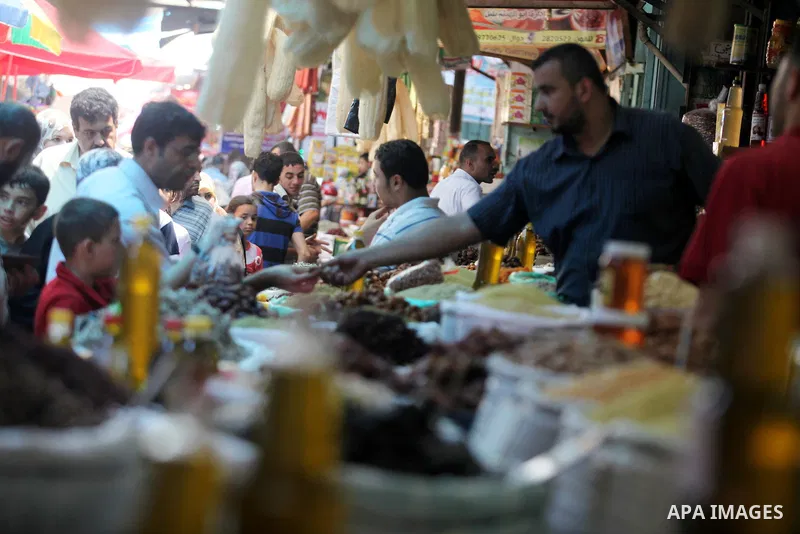 Palestinians Inspect goods as the vendor displays it in preparation for the holy month of Ramadan in the Gaza city on July 17, 2012 . Islam's holy month of Ramadan will begin in few days depending on the sighting of the...