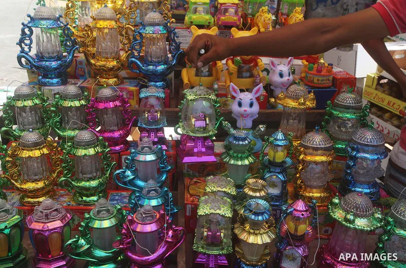 A Palestinian vendor displays goods in preparation for the holy month of Ramadan in the Gaza city on July 17, 2012 . Islam's holy month of Ramadan will begin in few days depending on the sighting of the crescent moon. Mu...
