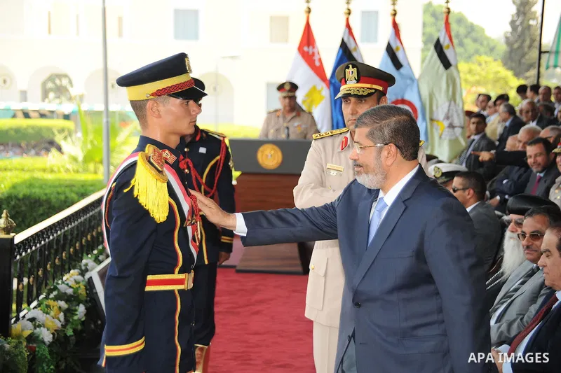 Egyptian President Mohamed Morsi honoring a military cadet during a medal ceremony for graduates at the Egyptian Military Academy in Cairo July 17, 2012. Fadi Fares / Egyptian Presidency
