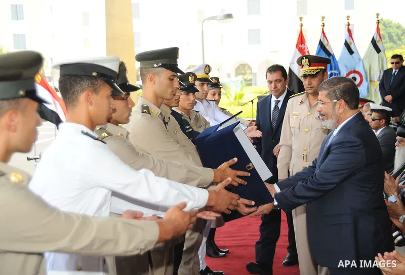 Egyptian President Mohamed Morsi honoring a military cadet during a medal ceremony for graduates at the Egyptian Military Academy in Cairo July 17, 2012. Fadi Fares / Egyptian Presidency