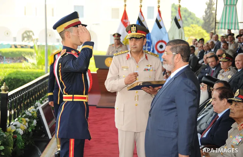 Egyptian President Mohamed Morsi honoring a military cadet during a medal ceremony for graduates at the Egyptian Military Academy in Cairo July 17, 2012. Fadi Fares / Egyptian Presidency