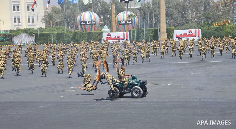 Egyptian troops demonstrate their skills at a graduation ceremony attended by President Mohammed Morsi, unseen, in Cairo, Egypt, Tuesday, July 17, 2012. Egypt's President Mohammed Morsi hailed the Egyptian army and its c...