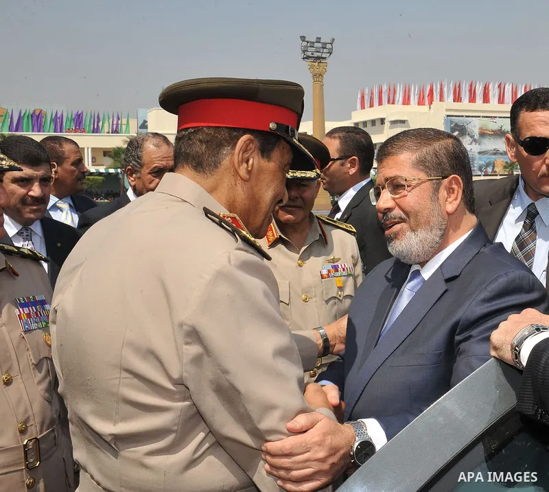 Egypt's Islamist President Mohamed Mursi (R) shakes hands with Egyptian Field Marshal Hussein Tantawi after a medal ceremony for graduates at the Egyptian Military Academy in Cairo July 17, 2012. Photo by Sherif Abd Mona...