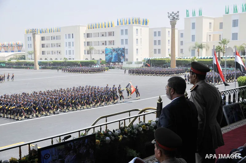 President Mohammed Morsi, second from right, and Field Marshal Hussein Tantawi, right, attend a military graduation ceremony in Cairo, Egypt, Tuesday, July 17, 2012. Egypt's President Mohammed Morsi hailed the Egyptian a...