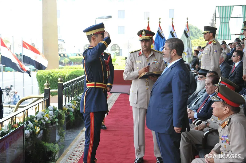 Egyptian President Mohamed Morsi honoring a military cadet during a medal ceremony for graduates at the Egyptian Military Academy in Cairo July 17, 2012. Sherif Abd Monam / Egyptian Presidency