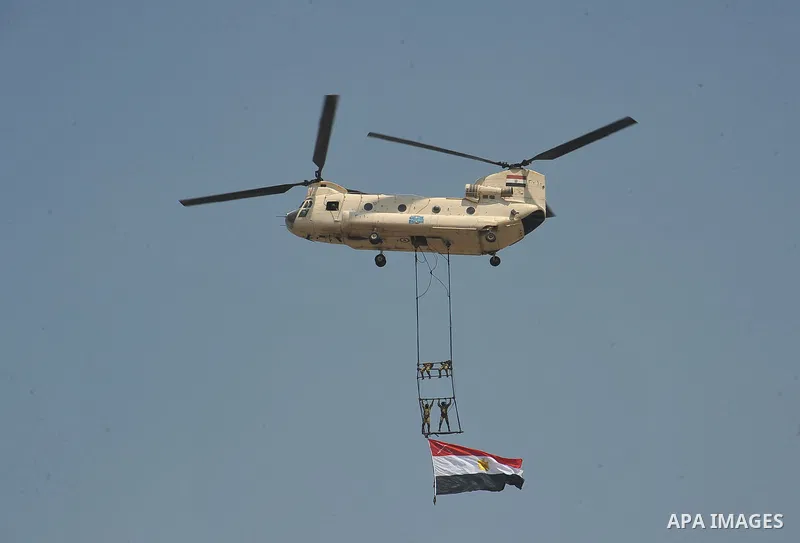 Egyptian troops demonstrate their skills at a graduation ceremony attended by President Mohammed Morsi, unseen, in Cairo, Egypt, Tuesday, July 17, 2012. Egypt's President Mohammed Morsi hailed the Egyptian army and its c...
