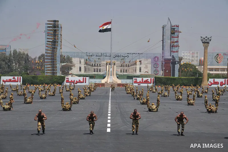 Egyptian troops demonstrate their skills at a graduation ceremony attended by President Mohammed Morsi, unseen, in Cairo, Egypt, Tuesday, July 17, 2012. Egypt's President Mohammed Morsi hailed the Egyptian army and its c...