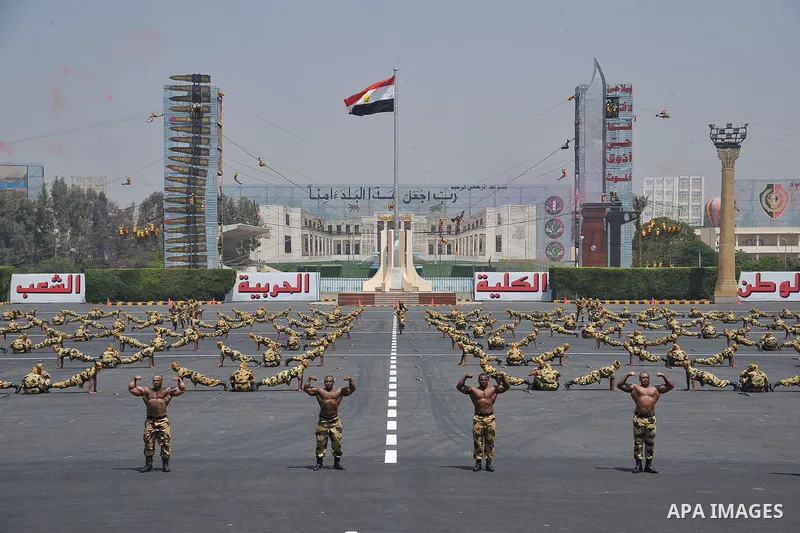 Egyptian troops demonstrate their skills at a graduation ceremony attended by President Mohammed Morsi, unseen, in Cairo, Egypt, Tuesday, July 17, 2012. Egypt's President Mohammed Morsi hailed the Egyptian army and its c...