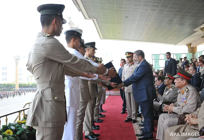Egyptian President Mohamed Morsi honoring a military cadet during a medal ceremony for graduates at the Egyptian Military Academy in Cairo July 17, 2012. Sherif Abd Monam / Egyptian Presidency