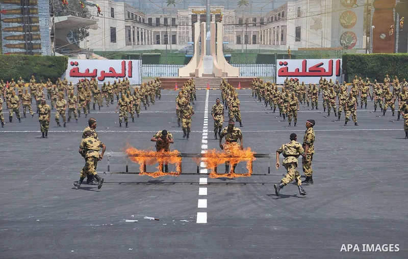 Egyptian troops demonstrate their skills at a graduation ceremony attended by President Mohammed Morsi, unseen, in Cairo, Egypt, Tuesday, July 17, 2012. Egypt's President Mohammed Morsi hailed the Egyptian army and its c...
