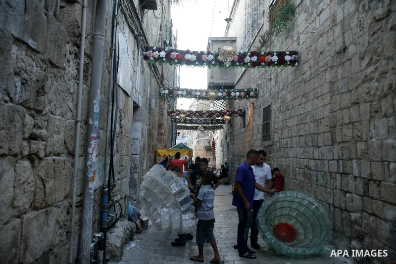 Palestinians hang up decorations before the Muslim holy month of Ramadan at a popular market in the old city of Jerusalem on July 17, 2012. The Muslim holy month of Ramadan begins Saturday 21 July , is traditionally dete...