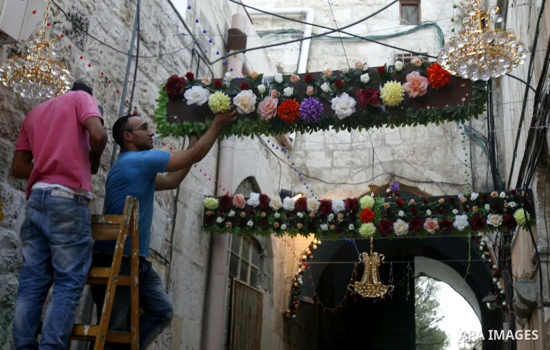 Palestinians hang up decorations before the Muslim holy month of Ramadan at a popular market in the old city of Jerusalem on July 17, 2012. The Muslim holy month of Ramadan begins Saturday 21 July , is traditionally dete...
