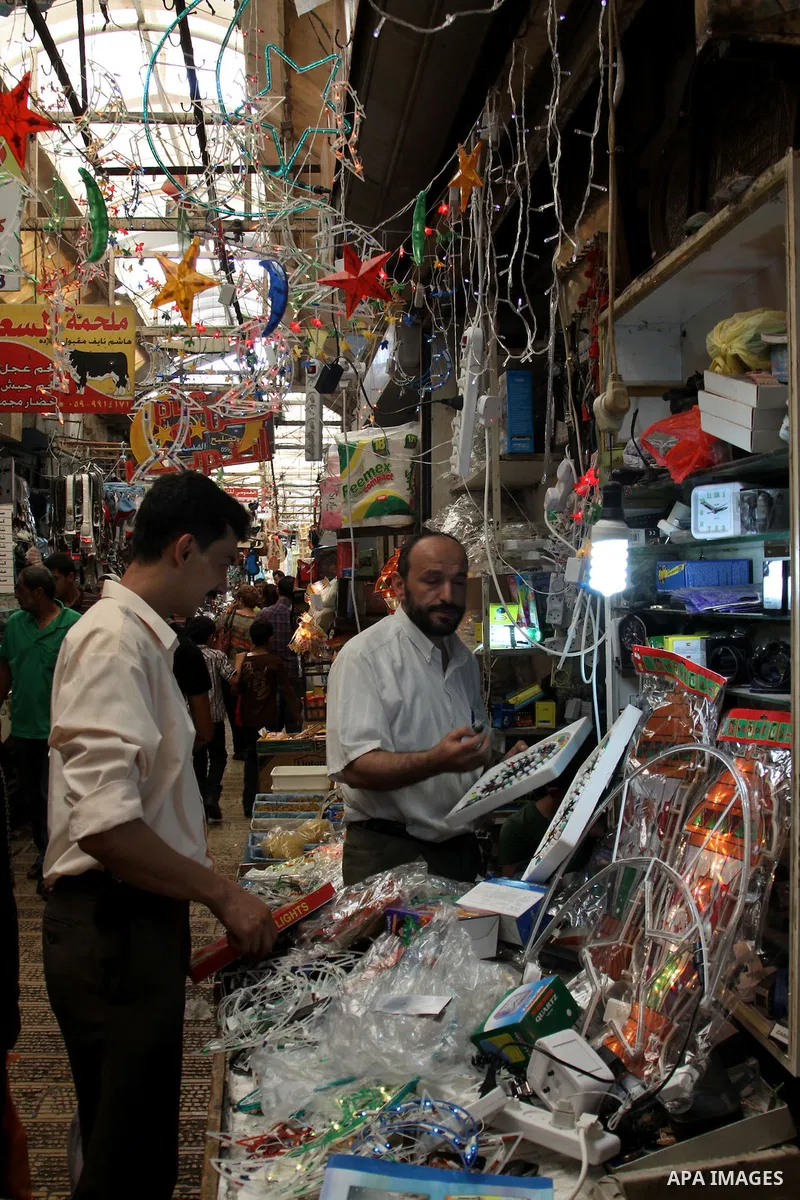 A Palestinian vendor decorates his shop with an electric crescent in preparation for the holy month of Ramadan in the West Bank city of Nablus, on July 18, 2012 . Islam's holy month of Ramadan will begin in few days depe...