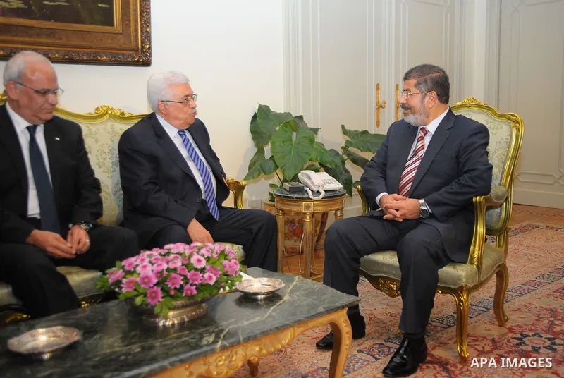 Egyptian President Mohamed Morsi (R) meeting with his Palestinian counterpart Mahmud Abbas, Palestinian negotiator Saeb Erakat (L) at the presidential palace in Cairo on July 18, 2012. Mohammed Smaha / Egyptian Presidenc...