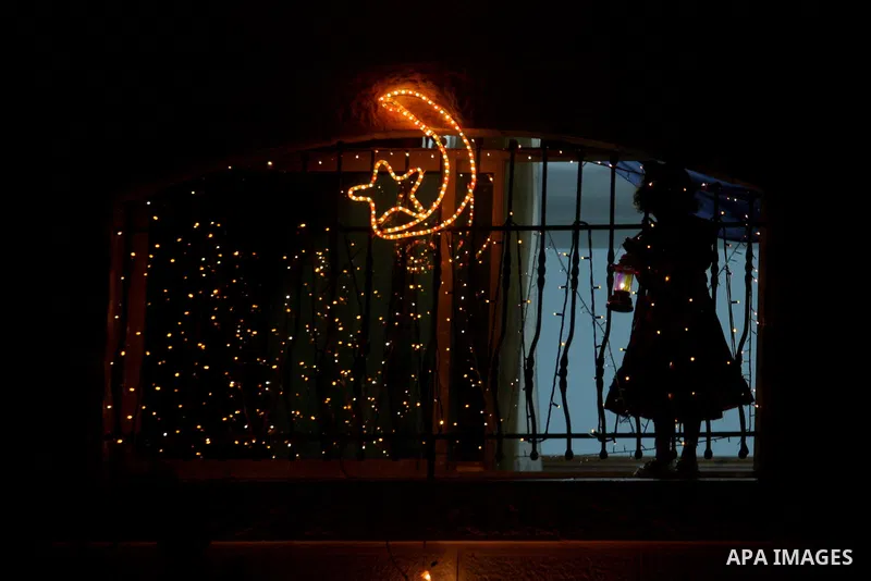 Palestinians hang up decorations before the Muslim holy month of Ramadan and write in Arabic, (Ramadan Karim) in their house in al-Bireh close to the West Bank city of Ramallah on July 18, 2012. The Muslim holy month of...