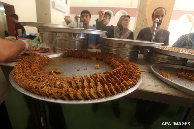 Palestinian vendors distribute sweets after the results of high school exams, or "Tawjihi", in Gaza city on July 19, 2012. Photo by Ashraf Amra