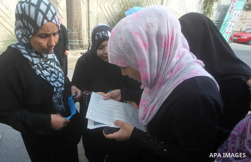 Palestinian secondary school students read a local newspaper to find their results in Gaza city on July 19, 2012. The Ministry of Education in Gaza Strip and the West Bank announced the results together. Photo by Ashraf...