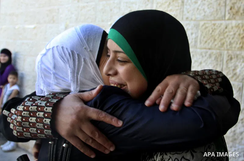 Palestinian high school students take hug after heard their results of final exams known as "Tawjihi" in the West Bank city of Nablus, on July 19, 2012. The Ministry of Education in Gaza Strip announced the final results...