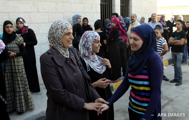 Palestinian high school students take hug after heard their results of final exams known as "Tawjihi" in the West Bank city of Nablus, on July 19, 2012. The Ministry of Education in Gaza Strip announced the final results...