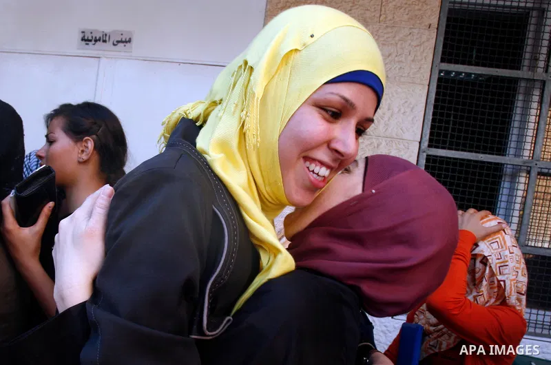 Palestinian high school students take hug after heard their results of final exams known as "Tawjihi" in Jerusalem, on July 19, 2012. The Ministry of Education in Gaza Strip announced the final results coincide with the...