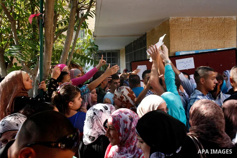Palestinians high school students gather to read their results of final exams known as "Tawjihi" in Jerusalem, on July 19, 2012. The Ministry of Education in Gaza Strip announced the final results coincide with the West...