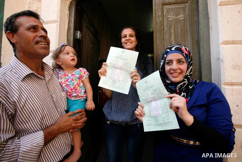 Palestinian high school students show the results of their final exams known as "Tawjihi" in Jerusalem, on July 19, 2012. The Ministry of Education in Gaza Strip announced the final results coincide with the West Bank. P...