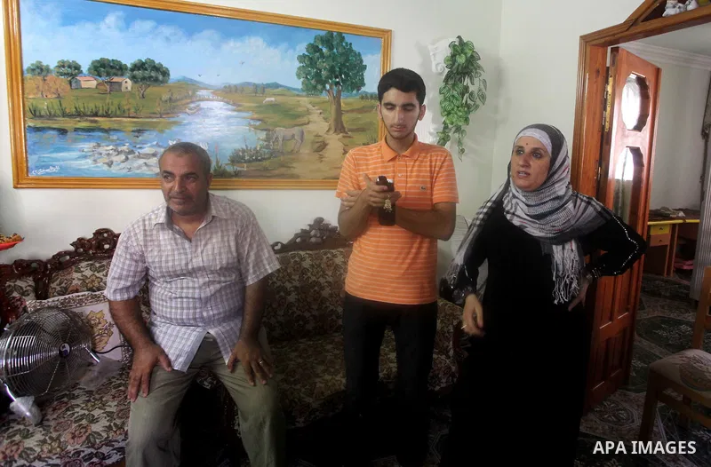 A Palestinian high school student and the third in section science, Bachar Anbar celebrates with his family after heard the results of her final exams known as "Tawjihi" in Gaza city, on July 19, 2012. The Ministry of Ed...