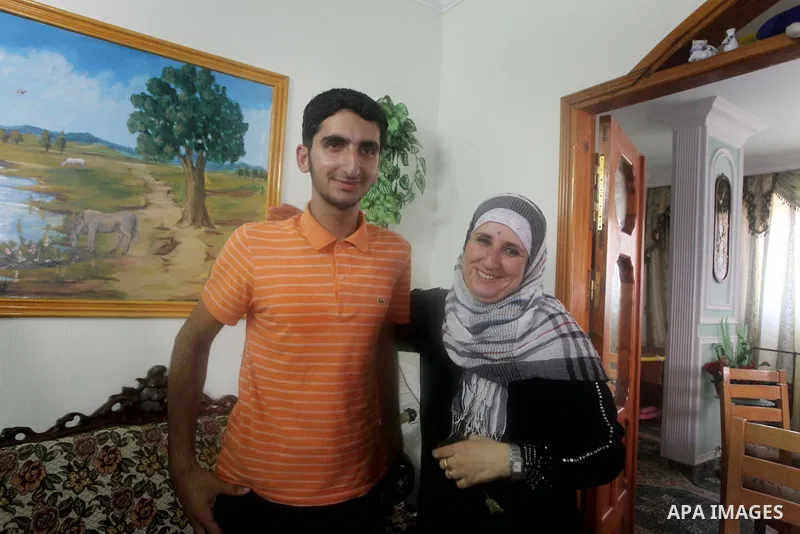 A Palestinian high school student and the third in section science, Bachar Anbar celebrates with his family after heard the results of her final exams known as "Tawjihi" in Gaza city, on July 19, 2012. The Ministry of Ed...