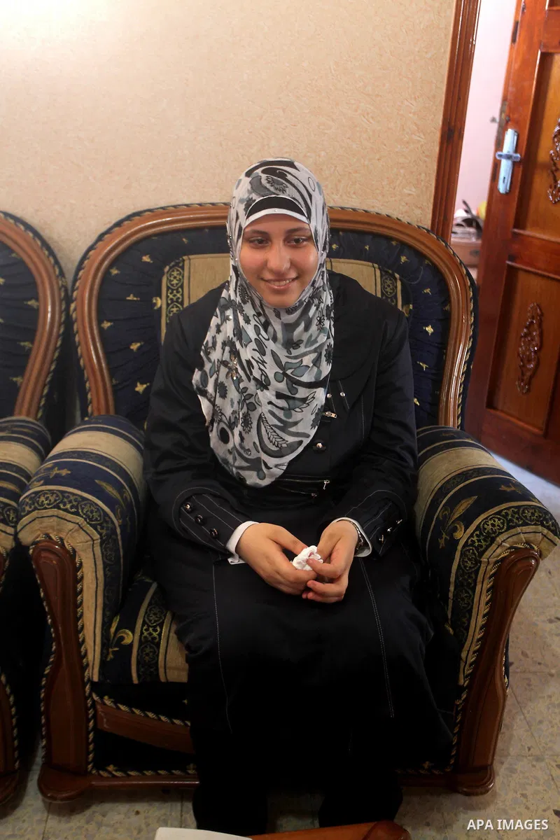 A Palestinian high school student and the sixth in section science, Muna Khalf allah celebrates with her family after heard the results of her final exams known as "Tawjihi" in Gaza city, on July 19, 2012. The Ministry o...