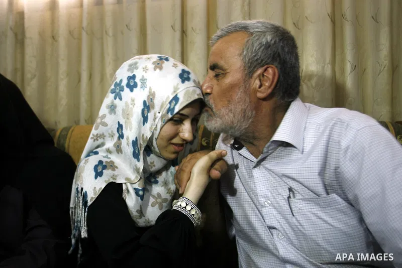 A Palestinian high school student, Nourhan Abu Obaid celebrates with her family after heard the results of her final exams known as "Tawjihi" in Rafah refugee camp southern Gaza strip, on July 19, 2012. The Ministry of E...