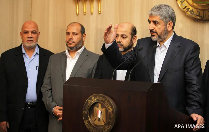 Hamas leader Khaled Meshaal (R) speaks during a news conference with Hamas delegates after their meeting with Egypt's President Mohamed Mursi at the presidential palace in Cairo July 19, 2012. Photo by Mohammed Al-Hams