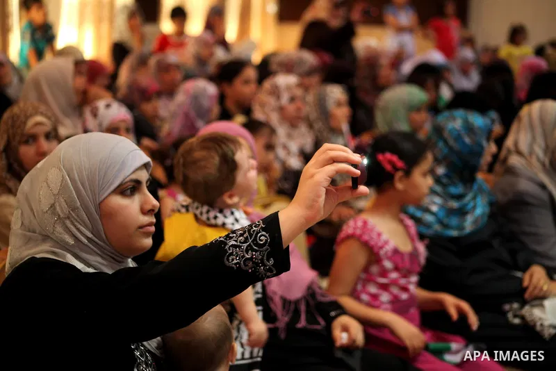 Palestinians attend the ceremony for superior high school students in Gaza city, on 19 July 2012. The Ministry of Education in Gaza Strip announced the final results of high school final exams known as ''Tawjihi'' coinci...