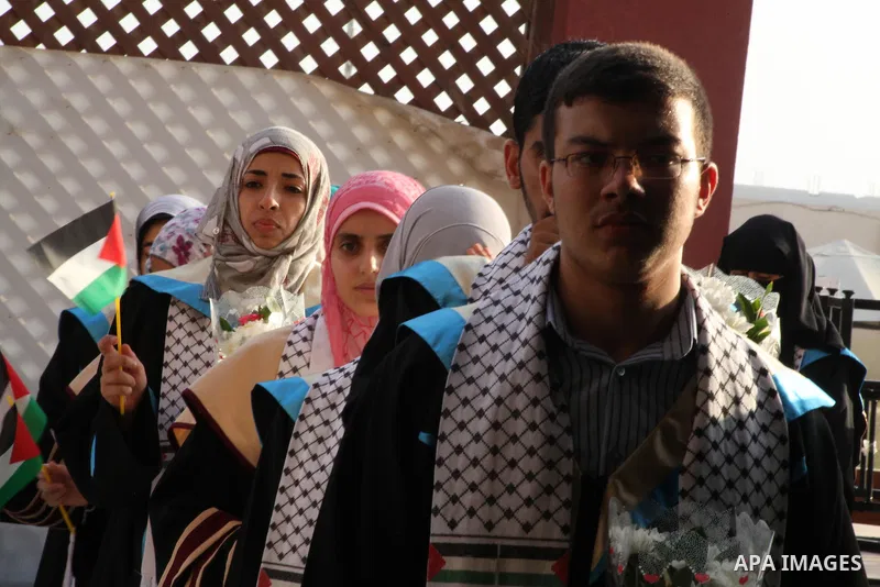 Palestinians attend the ceremony for superior high school students in Gaza city, on 19 July 2012. The Ministry of Education in Gaza Strip announced the final results of high school final exams known as ''Tawjihi'' coinci...
