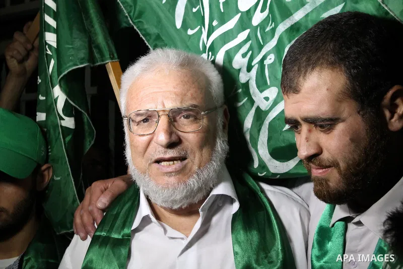Senior Hamas member Abdel Aziz Dweik celebrates his release near the West Bank city Hebron, Thursday, July 19, 2012. Dweik, 64, was freed Thursday after serving six months in an Israeli jail without charges. Photo by Mam...