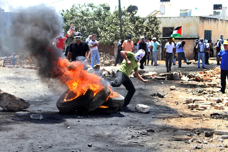 Palestinian protesters throw stones at Israeli troops during clashes as they protest against the Jewish settlement of Kdumim, near Nablus, West Bank, 20 July 2012. According to medical sources 16 Palestinians were injure...