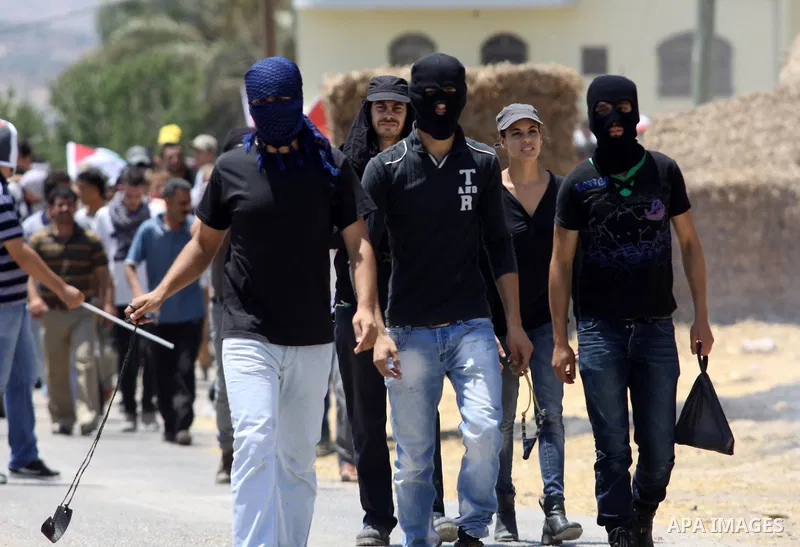 Palestinian protesters throw stones at Israeli troops during clashes as they protest against the Jewish settlement of Kdumim, near Nablus, West Bank, 20 July 2012. According to medical sources 16 Palestinians were injure...