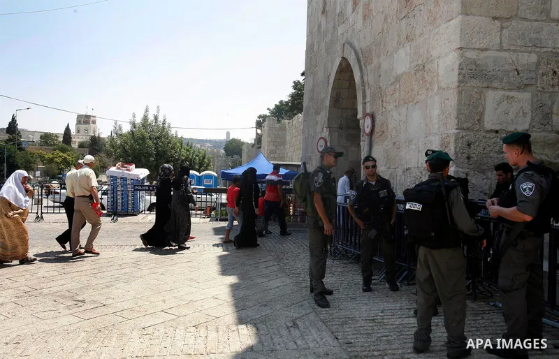 Israeli police officers stand guard as Palestinian muslim worshippers enter the compound of al-Aqsa mosque, known to Muslims as Noble Sanctuary and to Jews as Temple Mount in Jerusalem's Old City on the first Friday of t...