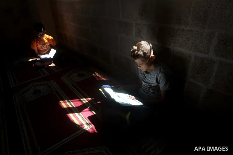 Palestinian children read the holy Qur'an at a mosque in Gaza city, on 21 July 2012. Muslims around the world refrain from eating, drinking and sexual intercourse from dawn till dusk during Ramadan, the holiest month in...