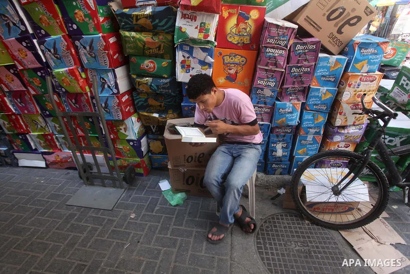 A Palestinian vendor reads the holy Qur'an in front of his shop in Gaza city, on 21 July 2012. Muslims around the world refrain from eating, drinking and sexual intercourse from dawn till dusk during Ramadan, the holiest...