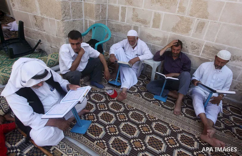 Palestinian muslims read the holy Qur'an at al-Omari mosque in Gaza city, on 21 July 2012. Muslims around the world refrain from eating, drinking and sexual intercourse from dawn till dusk during Ramadan, the holiest mon...