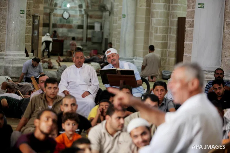 Palestinian muslims listen to sheikh during a religious lesson at al-Omari mosque in Gaza city, on 21 July 2012. Muslims around the world refrain from eating, drinking and sexual intercourse from dawn till dusk during Ra...
