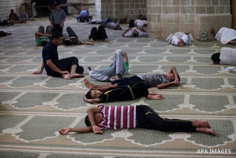 Palestinians take rest at a mosque in Gaza City on the second day of the month of Ramadan on 21 July 2012. Muslims around the world refrain from eating, drinking and sexual intercourse from dawn till dusk during Ramadan,...