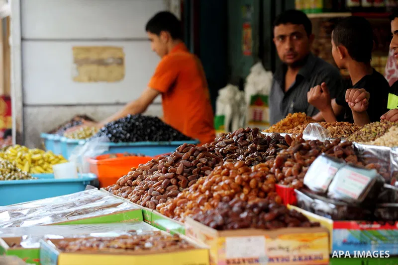 A Palestinian vendor displays goods in front of his shop in Gaza city on the second day of the holy month of Ramadan, on 21 July 2012. Muslims around the world abstain from eating, drinking and conducting sexual relation...