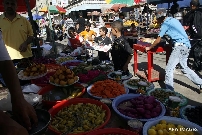 A Palestinian vendor sells pickles at a market on the second day of the holy month of Ramadan, at a shop in Rafah in south of Gaza Strip, on 21 July 2012. Muslims around the world abstain from eating, drinking and conduc...