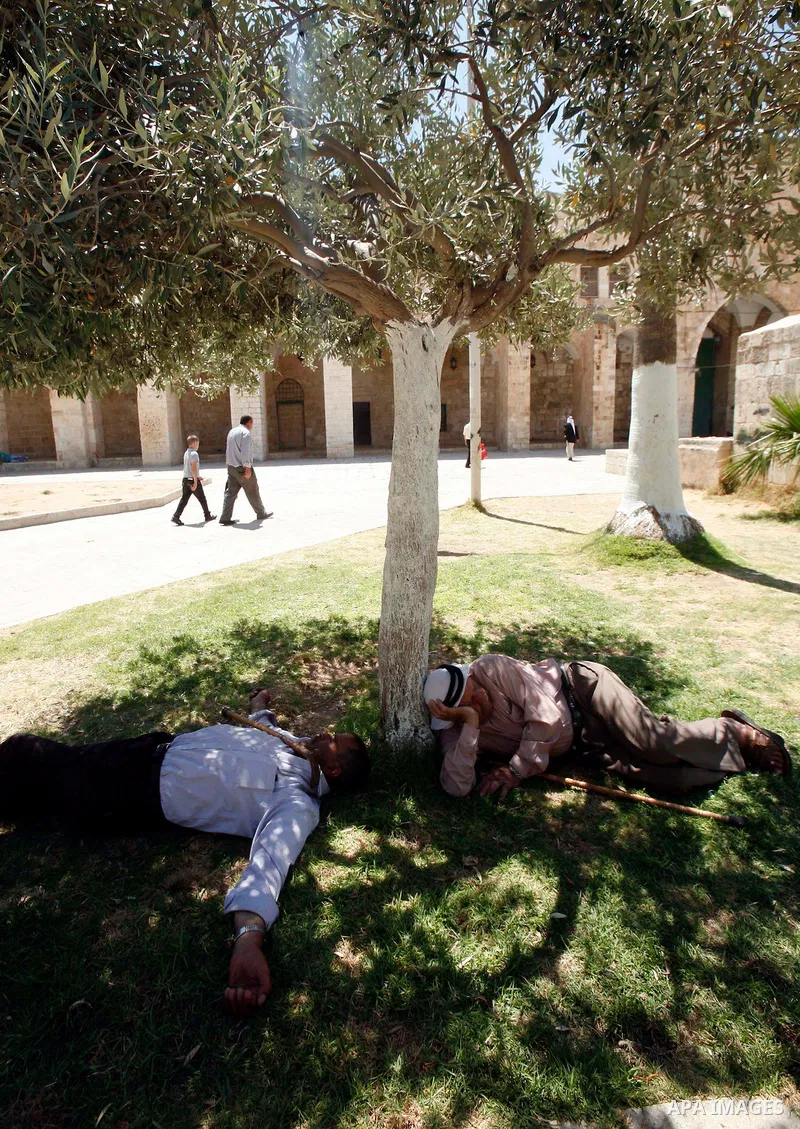 Palestinians take rest outside al-Aqsa Mosque in Jerusalem's Old City during the night prayer on the second day of the holy month of Ramadan, on 21 July 2012. Muslims around the world abstain from eating, drinking and co...